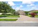 Charming home with a well-manicured lawn, mature landscaping, and brick paved driveway at 13819 American Prairie Pl, Bradenton, FL 34211