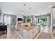 Open-concept kitchen and living area featuring an island with pendant lighting and backyard access at 13819 American Prairie Pl, Bradenton, FL 34211