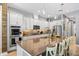 Modern kitchen with white cabinets, stainless steel appliances, and a large center island with seating at 13819 American Prairie Pl, Bradenton, FL 34211