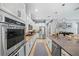 Modern kitchen boasts stainless steel appliances, stone countertops, and ample storage space at 13819 American Prairie Pl, Bradenton, FL 34211