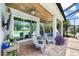 Covered lanai with brick floor, wood ceiling, ceiling fans, sitting area and view of the pool at 13819 American Prairie Pl, Bradenton, FL 34211