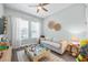 Well-decorated living room with soft colors, two windows and a comfortable sofa at 13819 American Prairie Pl, Bradenton, FL 34211