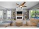 Bright living room featuring a fireplace, large sectional sofa, and modern décor at 13819 American Prairie Pl, Bradenton, FL 34211