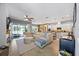 Open-concept living room, kitchen, and dining area with abundant natural light and stylish furnishings at 13819 American Prairie Pl, Bradenton, FL 34211