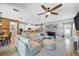 Open-concept home featuring living room, dining area, and a modern kitchen with white cabinetry at 13819 American Prairie Pl, Bradenton, FL 34211