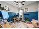 Bright office features blue accent walls, ceiling fan, window, desk, and a plush pink armchair at 13819 American Prairie Pl, Bradenton, FL 34211