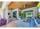 Spacious covered patio with comfortable seating, ceiling fans, and views of the lush backyard at 13819 American Prairie Pl, Bradenton, FL 34211