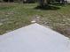 A blank concrete pad sits in the partially grassy backyard of this home, waiting for outdoor enjoyment at 1509 Overbrook Rd, Englewood, FL 34223