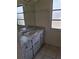 This bathroom features marble-patterned countertops, a vintage sink, and a large mirror above the vanity at 1509 Overbrook Rd, Englewood, FL 34223