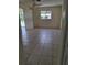 Bedroom features tile flooring, a window, and a ceiling fan at 1509 Overbrook Rd, Englewood, FL 34223