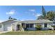 Charming single-story home with a well-maintained lawn and lovely curb appeal on a sunny day at 1509 Overbrook Rd, Englewood, FL 34223