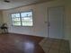 Bright room featuring laminate floors, and natural light from a large window at 1509 Overbrook Rd, Englewood, FL 34223