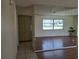 Large living room featuring laminate floors and a wall mirror at 1509 Overbrook Rd, Englewood, FL 34223