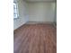 Spacious living room featuring laminate floors, neutral paint and natural light at 1509 Overbrook Rd, Englewood, FL 34223