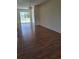 Open-concept living room with laminate flooring and sliding door access to the backyard at 1509 Overbrook Rd, Englewood, FL 34223