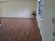 Bright living room with laminate flooring, neutral paint, and a window at 1509 Overbrook Rd, Englewood, FL 34223
