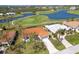 Beautiful aerial view of a home with an orange roof, with golf course and lake nearby at 16 Leeward Dr, Placida, FL 33946