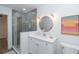 Well-lit bathroom with glass shower, herringbone tile wall and white vanity at 16 Leeward Dr, Placida, FL 33946