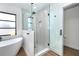 Sleek bathroom featuring a glass-enclosed shower, modern fixtures, and a standalone tub near a window at 16 Leeward Dr, Placida, FL 33946