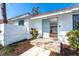 Front exterior featuring tile roof, stone steps, and landscaping at 16 Leeward Dr, Placida, FL 33946