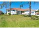 Charming single-story home with a tile roof, attached two-car garage, and lush front lawn at 16 Leeward Dr, Placida, FL 33946