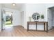 Bright foyer featuring console table, wood floors, and open doorway at 16 Leeward Dr, Placida, FL 33946