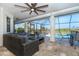 Screened lanai featuring modern furniture and views of the pool and landscape at 16 Leeward Dr, Placida, FL 33946