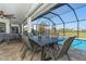 Screened lanai with outdoor dining and pool views at 16 Leeward Dr, Placida, FL 33946
