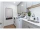 Laundry room featuring front loading washer and dryer and gray cabinets at 16 Leeward Dr, Placida, FL 33946