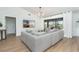 Living room has a large gray couch, sliding glass doors and a view of the back yard and golf course at 16 Leeward Dr, Placida, FL 33946