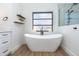 Elegant bathroom featuring a modern freestanding tub, wood floors, and stylish accents at 16 Leeward Dr, Placida, FL 33946