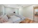 Bright bedroom with hardwood floors, white ceiling fan, and doorway to another room at 1610 S Orange Ave, Sarasota, FL 34239