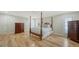 Spacious bedroom with a four-poster bed and hardwood floors at 1610 S Orange Ave, Sarasota, FL 34239