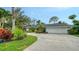Sprawling home exterior featuring lush landscaping, a long driveway, and a two car garage at 1610 S Orange Ave, Sarasota, FL 34239