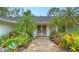 Up close, front entrance featuring a stone path and lush landscaping at 1610 S Orange Ave, Sarasota, FL 34239