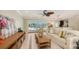 Living room with tile flooring, ceiling fan, access to the kitchen, and a view of pool at 1610 S Orange Ave, Sarasota, FL 34239