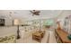 Bright living room area showcasing tile flooring, ceiling fan, and access to kitchen at 1610 S Orange Ave, Sarasota, FL 34239