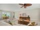 Living room with tile flooring, ceiling fan, and large windows with shutters at 1610 S Orange Ave, Sarasota, FL 34239