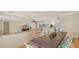 Open-concept living space that features tile flooring, large windows, and kitchen in background at 1610 S Orange Ave, Sarasota, FL 34239