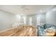 Well-lit office space with hardwood floors, statement desk, blue sofa, and three windows at 1610 S Orange Ave, Sarasota, FL 34239