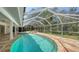 Enclosed pool with spa and surrounding stone tile in private backyard at 1610 S Orange Ave, Sarasota, FL 34239