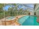 Outdoor pool with an attached hot tub and a screened-in enclosure at 1610 S Orange Ave, Sarasota, FL 34239