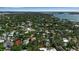 Overhead view of a residential neighborhood with a mix of homes, mature trees, and a glimpse of a blue swimming pool at 1677 Hyde Park St, Sarasota, FL 34239
