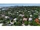 Panoramic aerial view of a neighborhood showcasing lush trees, well-maintained homes, and a cityscape backdrop at 1677 Hyde Park St, Sarasota, FL 34239