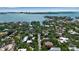 Stunning aerial view showcasing waterfront property in a serene location with beautiful blue water and lush greenery at 1677 Hyde Park St, Sarasota, FL 34239