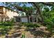Open backyard with brick patio, manicured plants, and large windows allowing for ample natural light in the house at 1677 Hyde Park St, Sarasota, FL 34239