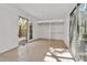 Sun-drenched bedroom with sliding doors leading to a private courtyard and built-in shelving at 1677 Hyde Park St, Sarasota, FL 34239
