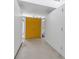 Bright entryway featuring a vibrant yellow double door and minimalist white walls, creating a modern aesthetic at 1677 Hyde Park St, Sarasota, FL 34239