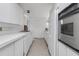Streamlined kitchen featuring sleek white cabinets, stainless steel appliances, and efficient design at 1677 Hyde Park St, Sarasota, FL 34239