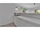 Modern kitchen with a cooktop, white countertops, and an adjacent window offering natural light at 1677 Hyde Park St, Sarasota, FL 34239